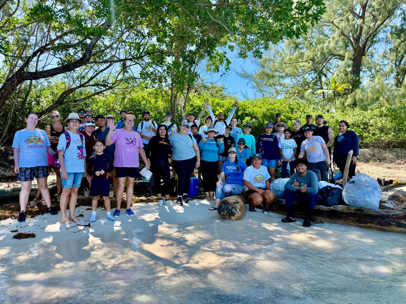 A large team gathers on sunny Don Quick Set Beach on January 24th 2026 to protect local ecosystems.
